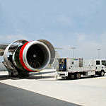 An EcoPower truck washing an airplane. 