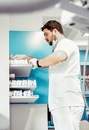 Dentist archiving patient prosthesis examinations in his clinic.