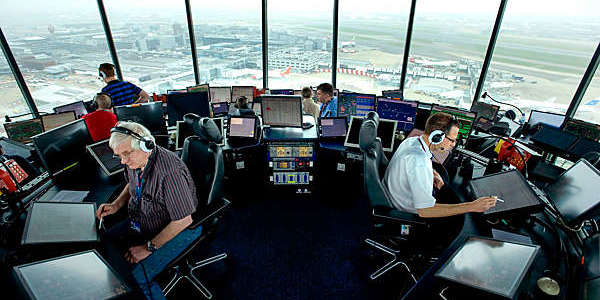 Air traffic controllers at work in the Heathrow Airport air traffic control tower.