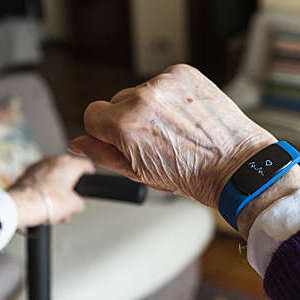 Elderly woman hand and detail of her smartwatch.
