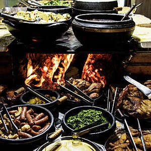 Typical dishes from Minas Gerais, Brazil, laid out in front of a wood stove.