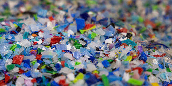 Multi-colored plastic flakes at a recycling center. Photographer: SeongJoon Cho/Bloomberg