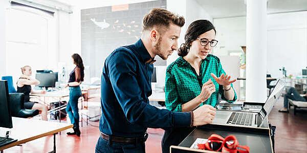 A group of startup business employees working together in a modern office environment.